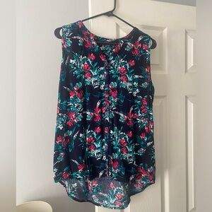 Navy sleeveless button down with floral print and high low hem. Size medium.